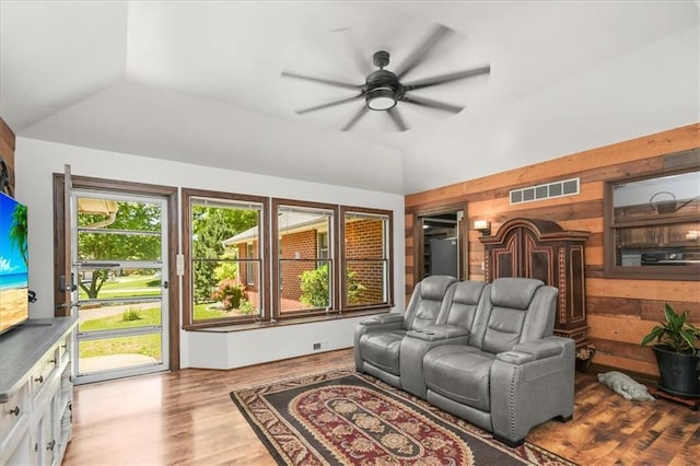 601 Darrow St, Warrensburg, MO 64093 - living room with a ceiling fan, wooden walls, wood finished floors, and lofted ceiling