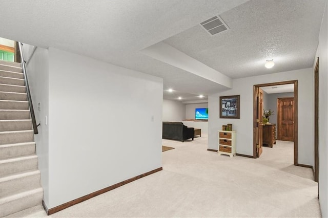 601 Darrow St, Warrensburg, MO 64093 - finished basement featuring light carpet, stairway, and a textured ceiling