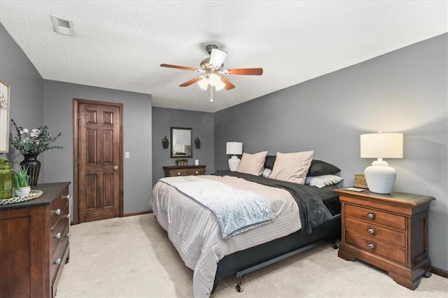 601 Darrow St, Warrensburg, MO 64093 - bedroom featuring light colored carpet, ceiling fan, and a textured ceiling