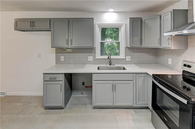 12825 E 50th Ter S, Independence, MO 64055 - kitchen with black / electric stove, wall chimney range hood, gray cabinets, decorative backsplash, and light countertops