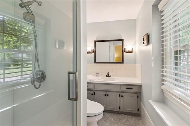 9934 Ballentine Dr, Overland Park, KS 66214 - full bathroom with a stall shower, vanity, and decorative backsplash