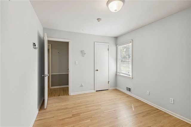 9934 Ballentine Dr, Overland Park, KS 66214 - unfurnished bedroom with light wood-type flooring and baseboards