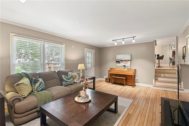 9934 Ballentine Dr, Overland Park, KS 66214 - living room with light wood finished floors, crown molding, plenty of natural light, and track lighting