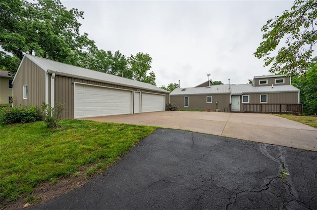 8231 Mike O Vince Rd, Ozawkie, KS 66070 - view of front of home featuring a garage, an outbuilding, and a metal roof