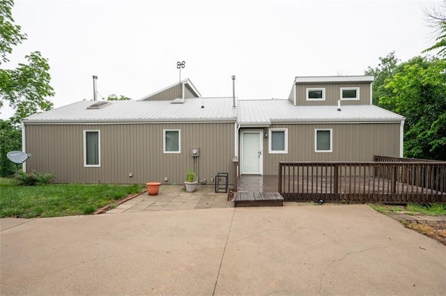 8231 Mike O Vince Rd, Ozawkie, KS 66070 - back of property with a patio, a wooden deck, and a metal roof