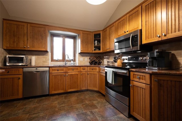 8231 Mike O Vince Rd, Ozawkie, KS 66070 - kitchen with appliances with stainless steel finishes, lofted ceiling, decorative backsplash, and dark stone finish floors