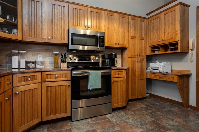 8231 Mike O Vince Rd, Ozawkie, KS 66070 - kitchen featuring appliances with stainless steel finishes, tasteful backsplash, stone tile floors, and brown cabinets