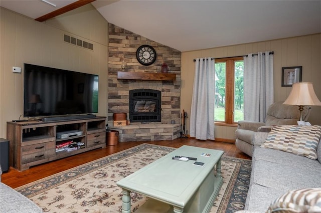8231 Mike O Vince Rd, Ozawkie, KS 66070 - living area featuring wood finished floors, lofted ceiling, a fireplace, and wood walls