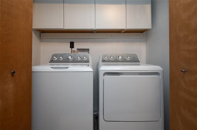 8231 Mike O Vince Rd, Ozawkie, KS 66070 - laundry area with washing machine and clothes dryer and cabinet space