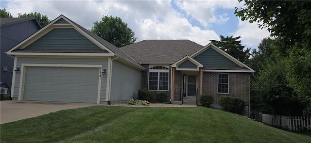 21241 W 123rd St, Olathe, KS 66061 - ranch-style house featuring a front yard, concrete driveway, an attached garage, and brick siding