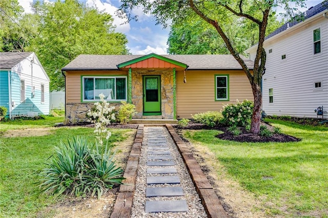 1504 Oak Hill Ave, Lawrence, KS 66044 - view of front facade with stone siding, a front lawn, and a shingled roof
