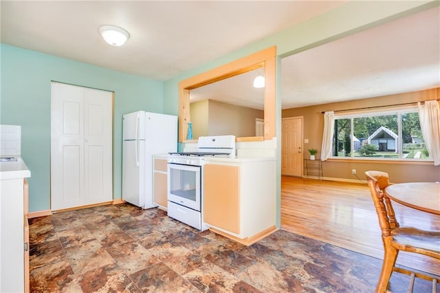 1504 Oak Hill Ave, Lawrence, KS 66044 - kitchen with white appliances, light countertops, and stone finish floors