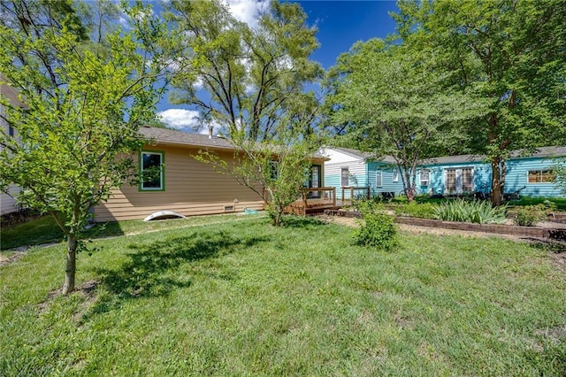 1504 Oak Hill Ave, Lawrence, KS 66044 - rear view of house with a yard and a deck