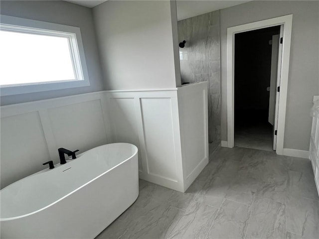 1709 SW Arbor Park Dr, Lees Summit, MO 64082 - full bathroom featuring marble look tiles, a decorative wall, a tile shower, a soaking tub, and wainscoting