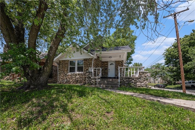 3842 E 68th Ter, Kansas City, MO 64132 - view of front of home with stone siding and a front lawn