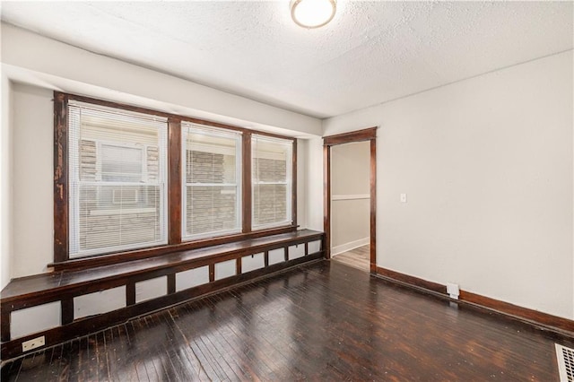 3842 E 68th Ter, Kansas City, MO 64132 - unfurnished room featuring hardwood / wood-style floors and a textured ceiling