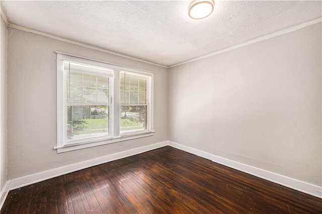 3842 E 68th Ter, Kansas City, MO 64132 - empty room with crown molding, dark wood-type flooring, and a textured ceiling
