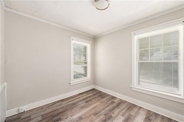3842 E 68th Ter, Kansas City, MO 64132 - spare room with dark wood-style flooring and crown molding