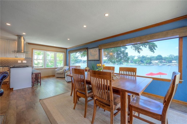 22 Emerald Shore Dr, Lake Tapawingo, MO 64015 - dining space with crown molding, light wood-style flooring, recessed lighting, a textured ceiling, and a water view