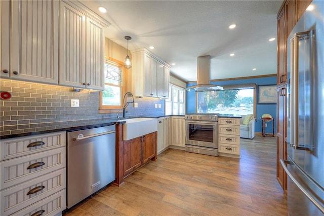 22 Emerald Shore Dr, Lake Tapawingo, MO 64015 - kitchen with high end appliances, island range hood, healthy amount of natural light, decorative backsplash, and recessed lighting