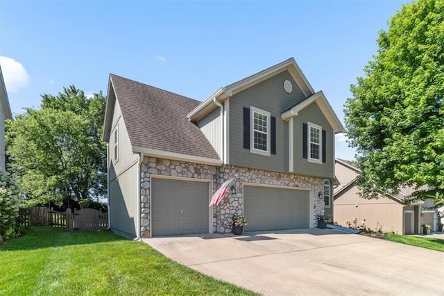 2125 SW Post Oak Rd, Lees Summit, MO 64082 - view of front facade featuring stone siding, driveway, roof with shingles, an attached garage, and a garage