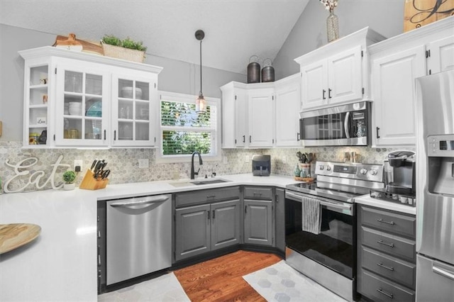 2125 SW Post Oak Rd, Lees Summit, MO 64082 - kitchen with gray cabinets, stainless steel appliances, lofted ceiling, white cabinets, and tasteful backsplash