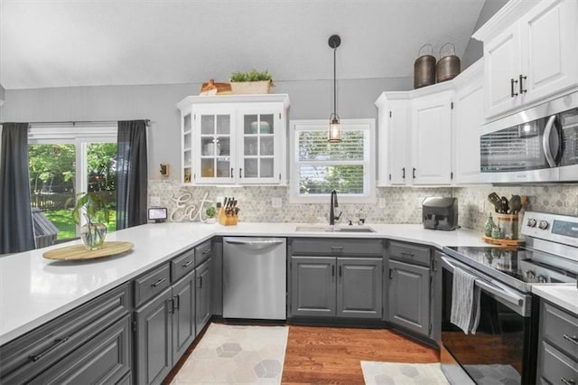 2125 SW Post Oak Rd, Lees Summit, MO 64082 - kitchen featuring appliances with stainless steel finishes, gray cabinets, white cabinets, and plenty of natural light
