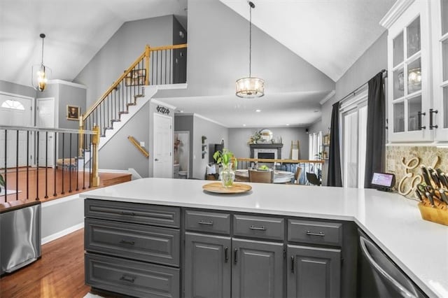 2125 SW Post Oak Rd, Lees Summit, MO 64082 - kitchen featuring gray cabinetry, dishwasher, a peninsula, light countertops, and hanging light fixtures