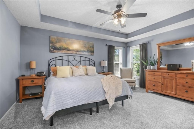2125 SW Post Oak Rd, Lees Summit, MO 64082 - bedroom featuring light carpet, a textured ceiling, a tray ceiling, and ceiling fan