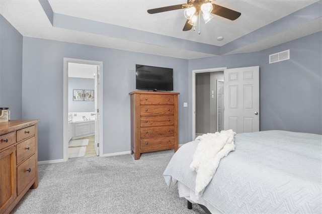 2125 SW Post Oak Rd, Lees Summit, MO 64082 - bedroom featuring a raised ceiling, light carpet, ensuite bathroom, and ceiling fan