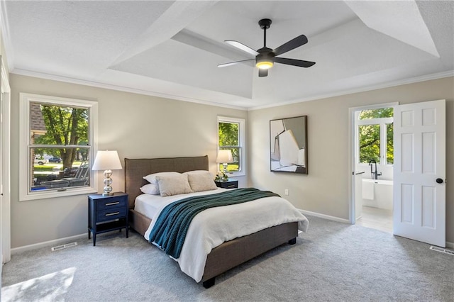 1424 E Meadow Ln, Olathe, KS 66062 - bedroom with a tray ceiling, multiple windows, light carpet, ornamental molding, and connected bathroom