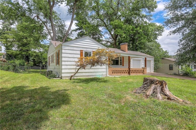 6605 Willow Ave, Raytown, MO 64133 - view of front of home featuring a chimney, driveway, and an attached garage