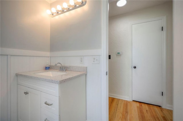 6605 Willow Ave, Raytown, MO 64133 - bathroom featuring vanity and wood finished floors