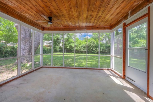 6605 Willow Ave, Raytown, MO 64133 - unfurnished sunroom featuring ceiling fan, healthy amount of natural light, and view of wooded area