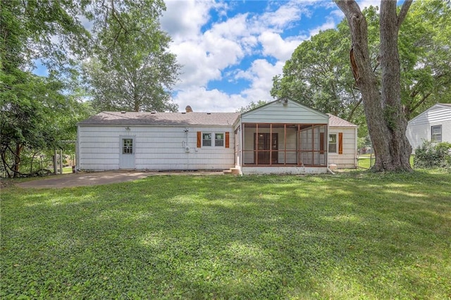 6605 Willow Ave, Raytown, MO 64133 - rear view of property with a sunroom, a yard, and a chimney