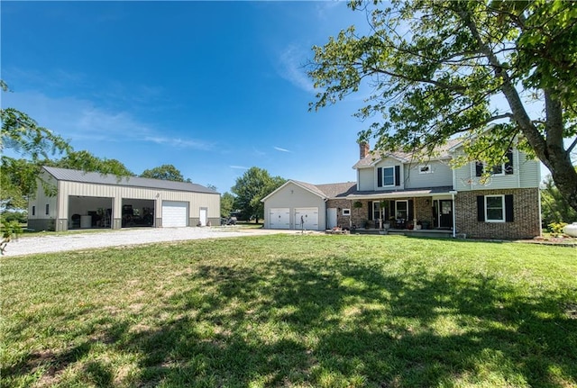 440 41p Rd, Clinton, MO 64735 - view of front of property with covered porch, a chimney, a front lawn, brick siding, and a garage