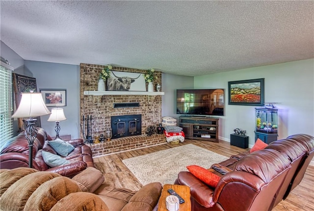 440 41p Rd, Clinton, MO 64735 - living room with a textured ceiling, a fireplace, and wood finished floors