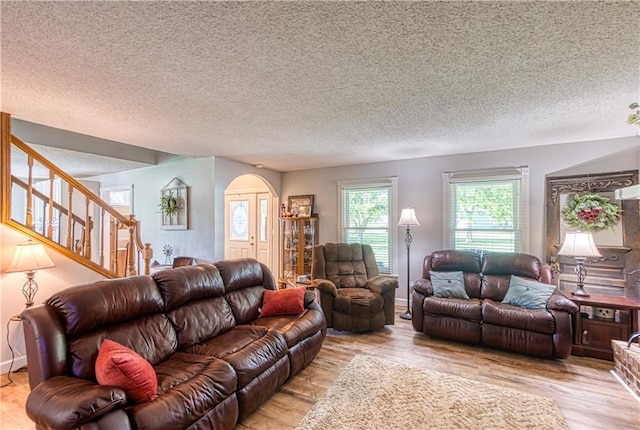 440 41p Rd, Clinton, MO 64735 - living area with wood finished floors, arched walkways, stairs, and a textured ceiling