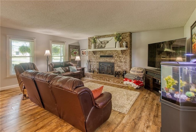 440 41p Rd, Clinton, MO 64735 - living room with wood finished floors, a textured ceiling, and a brick fireplace