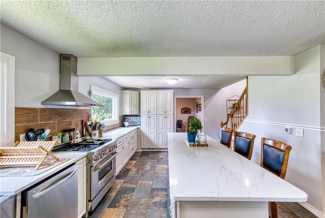 440 41p Rd, Clinton, MO 64735 - kitchen featuring extractor fan, stainless steel appliances, a textured ceiling, a kitchen island, and dark stone finish floors