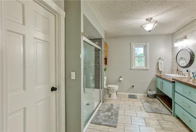 440 41p Rd, Clinton, MO 64735 - full bathroom with vanity, a stall shower, a textured ceiling, and tile patterned floors