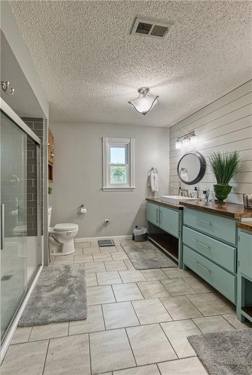 440 41p Rd, Clinton, MO 64735 - bathroom featuring vanity, a stall shower, and a textured ceiling