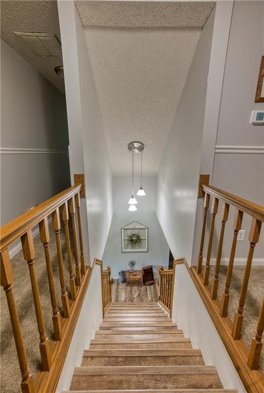 440 41p Rd, Clinton, MO 64735 - staircase featuring a textured ceiling and wood finished floors