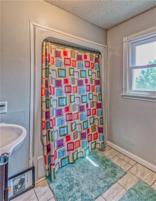 440 41p Rd, Clinton, MO 64735 - bathroom with a textured ceiling, a shower with shower curtain, and tile patterned flooring