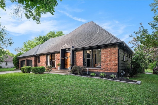 12419 Askew Dr, Grandview, MO 64030 - view of front of property with brick siding, a garage, a front yard, driveway, and roof with shingles