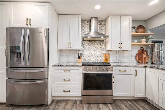 12419 Askew Dr, Grandview, MO 64030 - kitchen with stainless steel appliances, wall chimney range hood, white cabinets, and recessed lighting