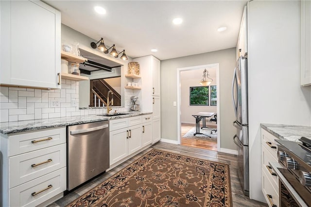 12419 Askew Dr, Grandview, MO 64030 - kitchen featuring appliances with stainless steel finishes, open shelves, backsplash, white cabinets, and light stone counters