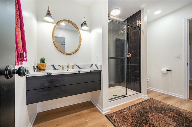 12419 Askew Dr, Grandview, MO 64030 - bathroom with wood finished floors, a stall shower, vanity, and recessed lighting