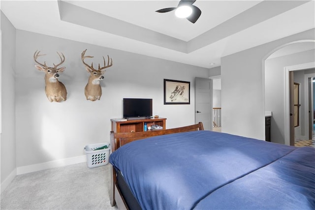 23717 W 118th Ter, Olathe, KS 66061 - bedroom featuring a tray ceiling, carpet flooring, arched walkways, and a ceiling fan