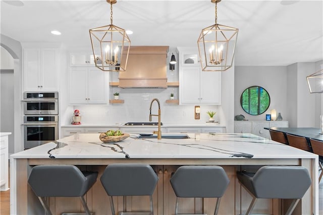 23717 W 118th Ter, Olathe, KS 66061 - kitchen with a chandelier, stainless steel double oven, custom exhaust hood, backsplash, and recessed lighting